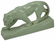 An Art Deco style green glazed tiger in walking pose raised on a base, no marks. length 35cm