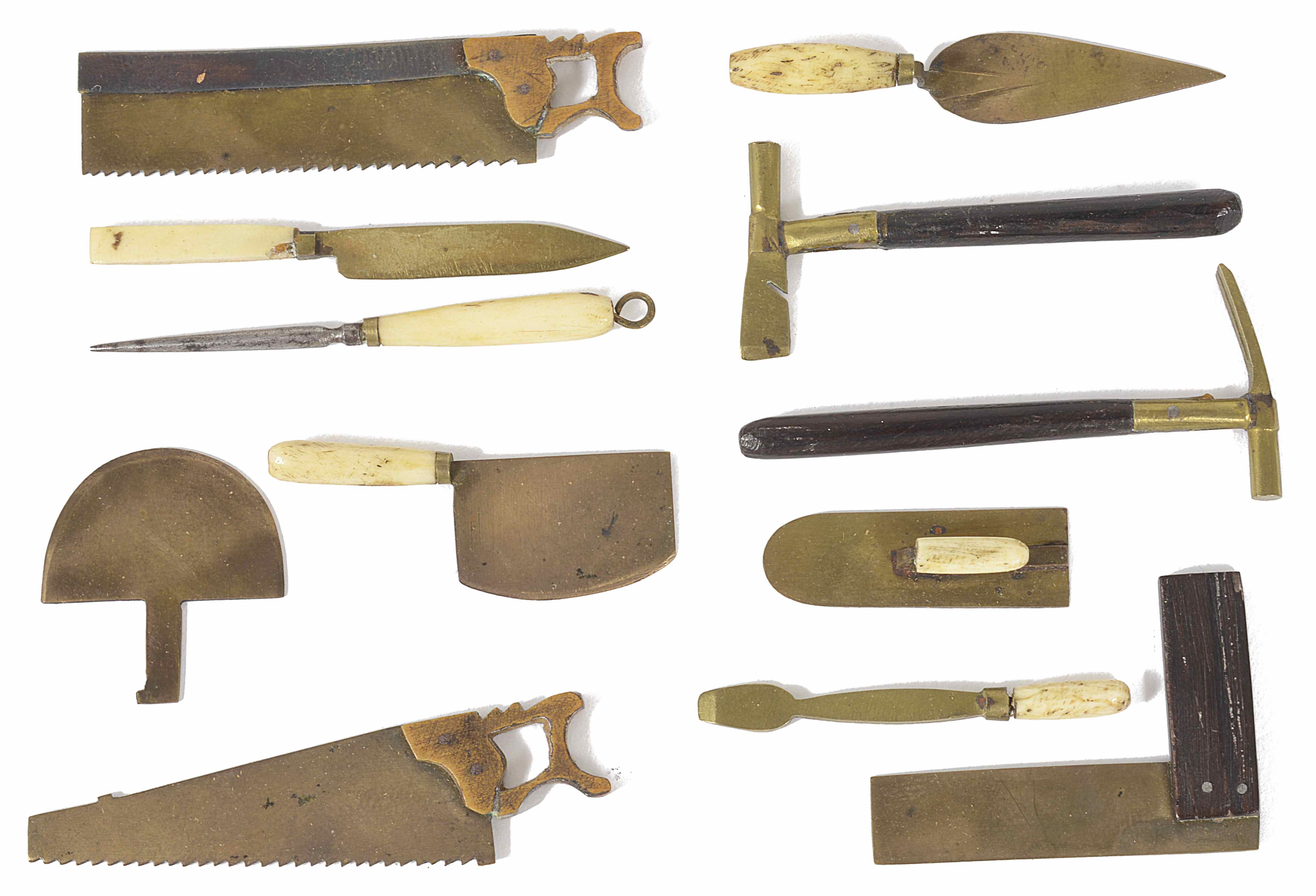 An unusual miniature bone/ivory and brass set of woodwork tools including a tenant saw, set