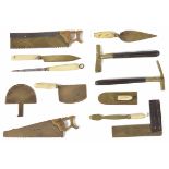 An unusual miniature bone/ivory and brass set of woodwork tools including a tenant saw, set