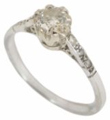 A delicate single stone diamond set ring the white metal mount with diamond detail to shoulders