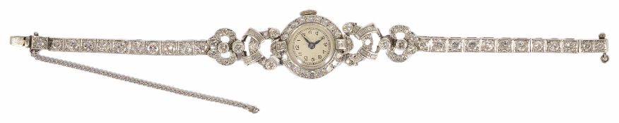 A platinum and diamond set ladies cocktail watch circa 1935, the circular dial diamond framed and