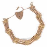 An Edwardian 9ct gold three bar gate bracelet with heart padlock fastening weight approx. 15.3
