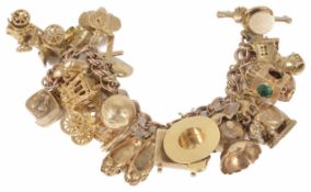 A 9ct gold charm bracelet with a rose gold chain and numerous charms, including cased solitaire