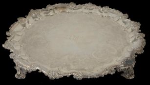 A large George IV silver tray hallmarked London 1828, with shaped scrolled border, raised upon