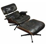 A Charles and Ray Eames rosewood and black leather lounge chair and ottoman (a.f) approximately