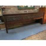 ANTIQUE OAK 18th CENTURY THREE DRAWER WELSH DRESSER BASE WITH CARVED DECORATION TO FRONT