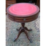 REPRODUCTION RED LEATHER TOPPED TWO DRAWER DRUM TABLE ON QUADRAFOIL SUPPORTS