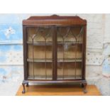 MAHOGANY BOW FRONTED TWO DOOR GLAZED DISPLAY CABINET ON BALL AND CLAW SUPPORTS
