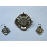 UNHALLMARKED SILVER COLOURED PIERCEWORK AND FLORAL DECORATION MOURNING BROOCH AND MATCHING EARRINGS