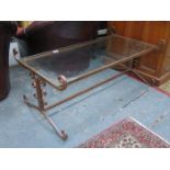 GLASS TOPPED COFFEE TABLE ON CAST METAL SUPPORTS