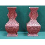 PAIR OF HAND CARVED RED CINNABAR LACQUERED VASES DECORATED WITH ORIENTAL FIGURES WITHIN COUNTRYSIDE