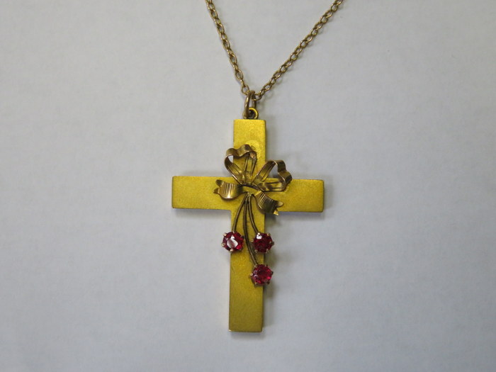 9ct GOLD CROSS SET WITH THREE RUBY COLOURED STONES ON 9ct GOLD CHAIN