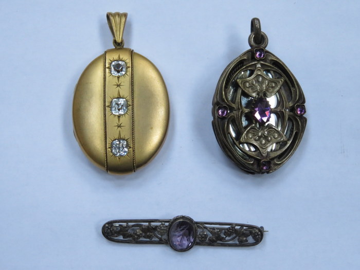 TWO DECORATIVE OVAL LOCKETS AND STERLING SILVER BROOCH