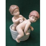 LLADRO GLAZED CERAMIC FIGURE GROUP OF TWO YOUNG BOYS GETTING WASHED