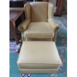 LEATHER UPHOLSTERED ARMCHAIR AND MATCHING FOOT STOOL