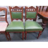 PAIR OF LEATHER UPHOLSTERED CARVED MAHOGANY DINING CHAIRS