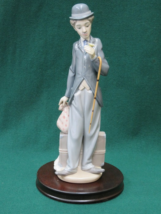 LLADRO GLAZED CERAMIC PIECE OF CHARLIE CHAPLIN ON WOODEN PLINTH 31cm