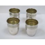 FOUR SMALL INDIAN STYLE SILVER COLOURED SHOT MEASURES
