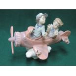 LLADRO GLAZED CERAMIC FIGURE GROUP OF CHILDREN IN A PLANE 17cm