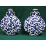 PAIR OF FLORAL DECORATED AND GILDED BLUE AND WHITE CERAMIC FLASKS,