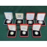 FOUR CASED ROYAL MINT SILVER PROOF 50p COINS AND THREE CASED ROYAL MINT SILVER PROOF £1 COINS