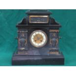 GILDED AND RELIEF DECORATED BLACK SLATE MANTEL CLOCK WITH ENAMELLED DIAL