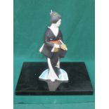 HAKAJA NINGYO DOLL OF A LADY ON A EBONISED STAND.