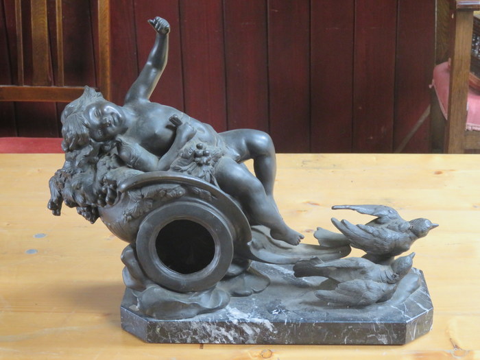 VICTORIAN STYLE BRONZE EFFECT RECLINING FORM FIGURE ON A MABLE BASE.