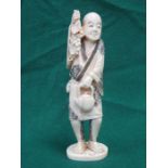 HEAVILY CARVED IVORY FIGURE OF AN ORIENTAL GENTLEMAN,