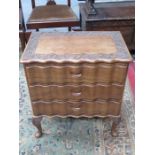SMALL CHEST OF THREE DRAWERS WITH CARVED DECORATION AND SERPENTINE FRONT