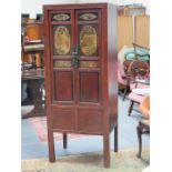 TWO DOOR LACQUERED STORAGE CABINET DECORATED WITH ORIENTAL SCENES TO PANELS