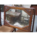 CARVED MAHOGANY FRAMED AND BEVELLED WALL MIRROR
