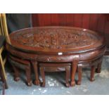 HEAVILY CARVED ORIENTAL STYLE OVAL NEST OF SEVEN TABLES