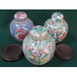 THREE VARIOUS FLORAL DECORATED ORIENTAL STYLE CERAMIC STORAGE JARS WITH COVERS