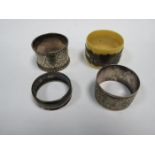 THREE HALLMARKED SILVER NAPKIN RINGS AND SILVER BANDED NAPKIN RING