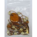 STRAND OF AMBER COLOURED BEADS