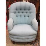 BLUE UPHOLSTERED BUTTON BACK LOW SEATED ARMCHAIR ON MAHOGANY SUPPORTS