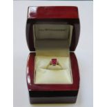 9ct GOLD DRESS RING SET WITH RUBY COLOURED STONE AND TWO CLEAR STONES