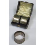CASED PAIR OF HALLMARKED SILVER NAPKIN RINGS AND ONE OTHER SILVER NAPKIN RING