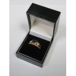 9ct GOLD DRESS RING SET WITH CLEAR STONES AND CENTRAL PURPLE COLOURED STONE