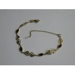 9ct GOLD BRACELET SET WITH RUBY COLOURED STONES