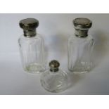 PAIR OF SILVER TOPPED GLASS BOTTLES PLUS ONE SMALLER