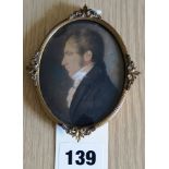 A framed portrait miniature portrait of a gentleman wearing a jacket and high necked shirt, 8 x