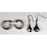 Two pairs of silver earrings.