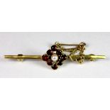 A 9ct gold garnet and seed pearl bar brooch.