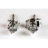 A pair of 18ct white diamond solitaire earrings.