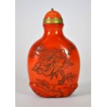 An interesting mid 20th century Chinese glass snuff bottle imitating coral with a gilt and hardstone