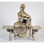 A Chinese silvered bronze figure of a monk seated on a bench, H. 18cm.