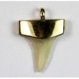 A yellow metal (tested min 9ct gold) mounted sharks tooth pendant.