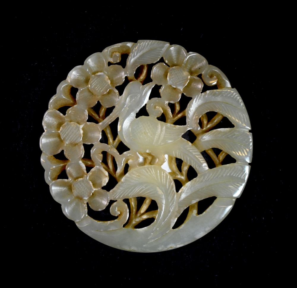 A Chinese carved jade disc of a pheasant among foliage, Dia. 5.8cm, Depth. 0.3cm, probably a 19th